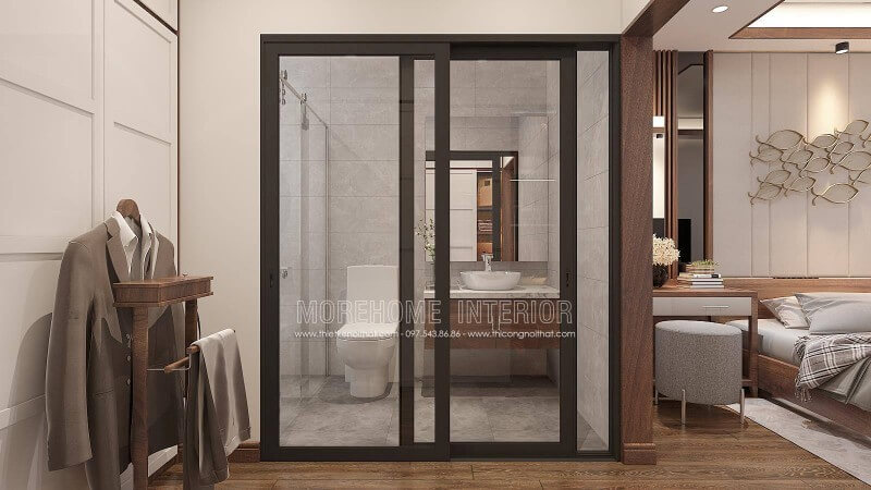 Thiết kế nội thất phòng ngủ khép kín với xu hướng mở khi sử dụng tấm ốp tường gỗ óc chó như tạo ranh giới phân chia cùng bố trí cửa kính trượt.